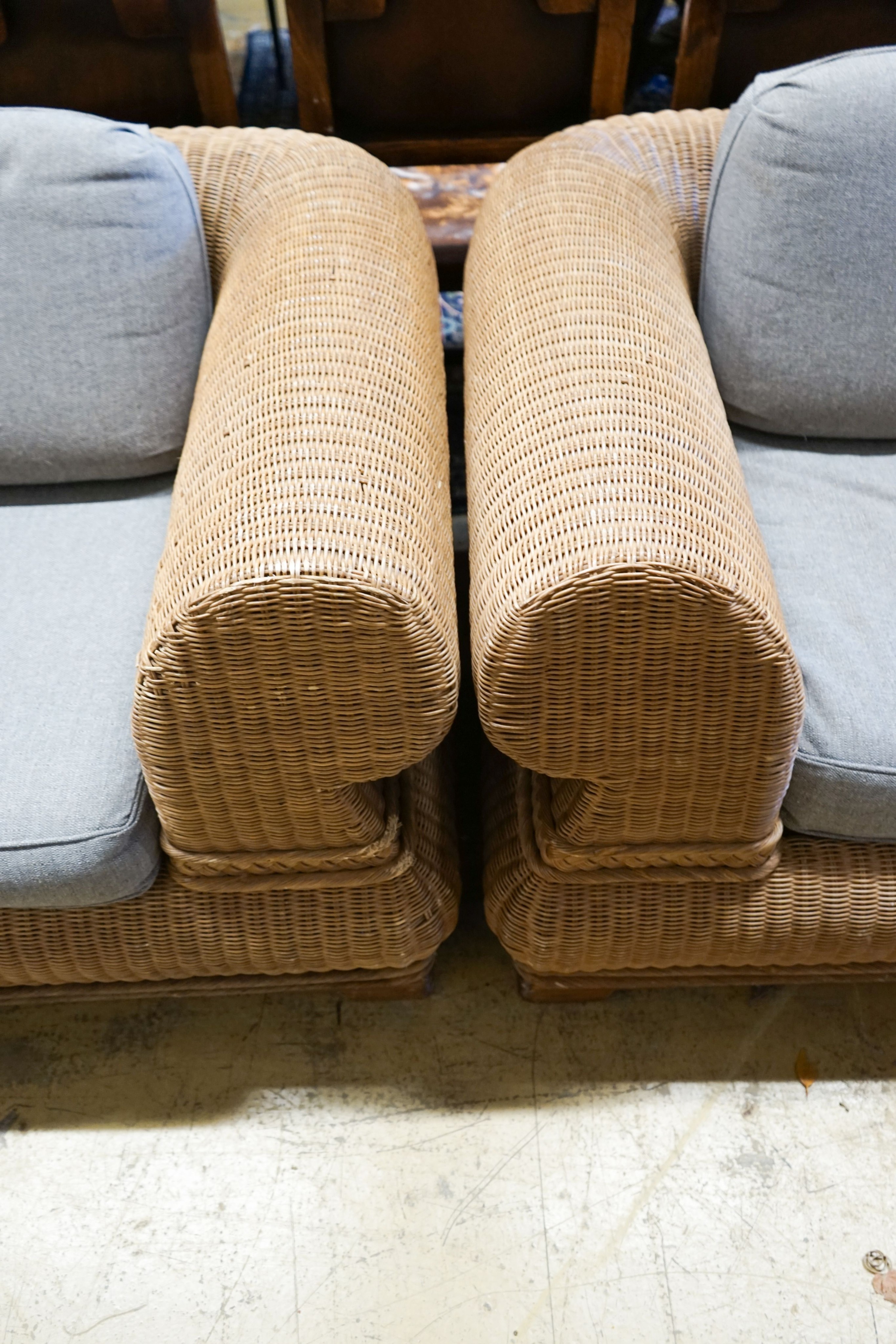 A pair of contemporary rattan conservatory settees, with grey fabric cushions, seats and backs, length 190cm, depth 100cm, height 70cm